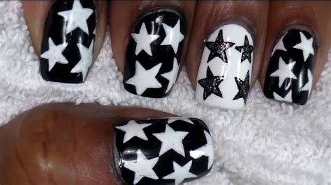 white nails with black stars|clear white with black nails.